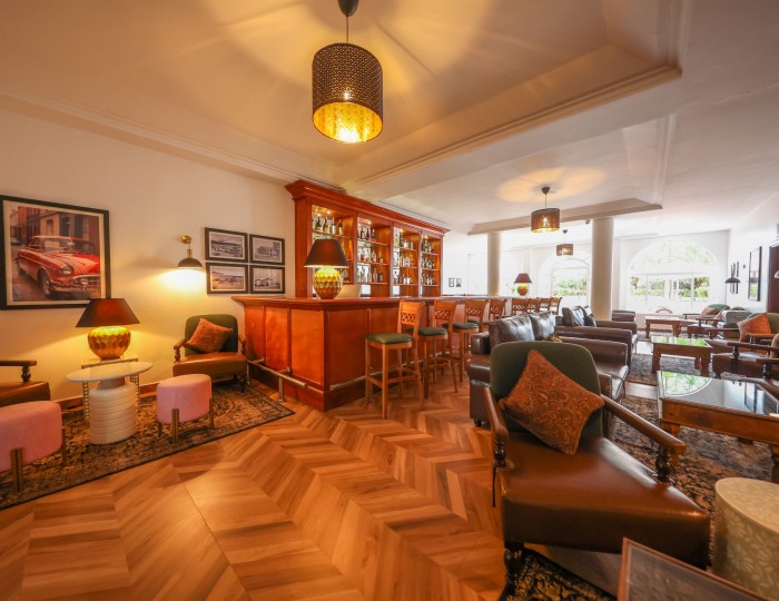 The wood-panelled 1950s Bar with herringbone floor, leather seating and framed prints.