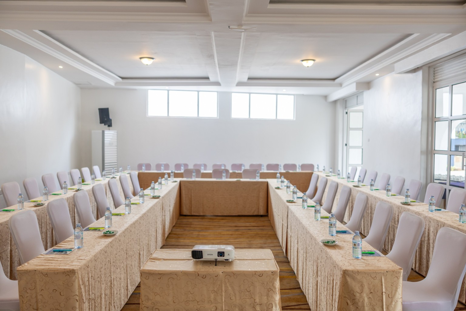 A boardroom-style table arrangement with a projector at its centre.