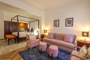 A sofa, armchairs and ottomans in the separate lounge area of an Executive Suite.