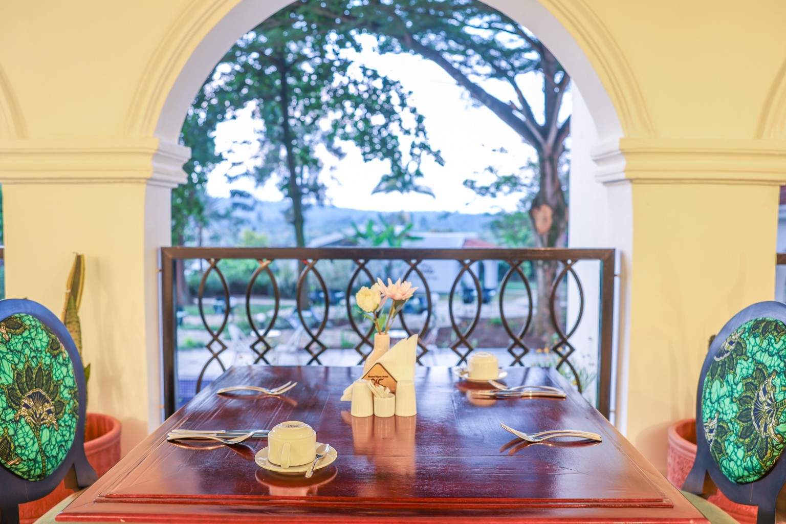 The long dining room under vaulted ceiling, arched windows down one side.