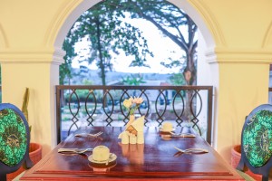 The long dining room under vaulted ceiling, arched windows down one side.