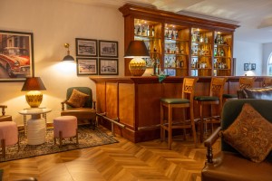 The wood-panelled 1950s Bar, with its herringbone floor, leather seating, framed prints and shelved spirits.