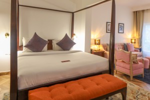 An Executive Suite with a four-poster king bed and a separate lounge area.
