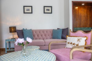 A guest room with king or twin beds, bedside lamps and curtained windows onto the garden.