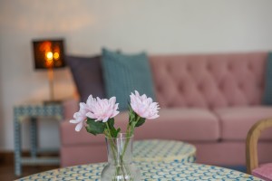 A guest room with king or twin beds, bedside lamps and curtained windows onto the garden.