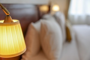 A guest room with king or twin beds, bedside lamps and curtained windows onto the garden.