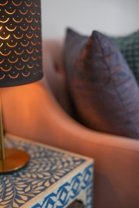 A guest room with king or twin beds, bedside lamps and curtained windows onto the garden.
