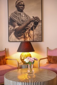Interior detail at the hotel: hanging cowbells, framed pictures and a chequerboard corridor floor.