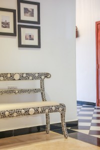 The lobby lounge, with sofas and armchairs beneath a wall of tall windows onto the garden.