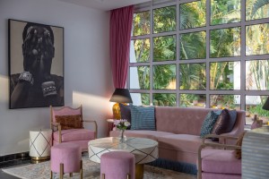 The lobby lounge, with sofas and armchairs beneath a wall of tall windows onto the garden.