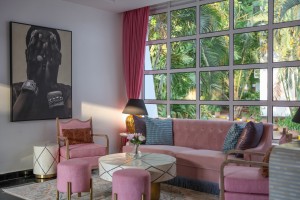 The lobby lounge, with sofas and armchairs beneath a wall of tall windows onto the garden.
