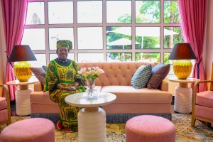 Sofas and armchairs in the lounge beneath tall windows onto the garden.