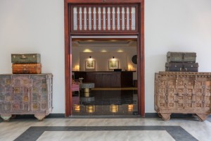 The reception hall and desk, framed by a timber doorway with painted chests either side.