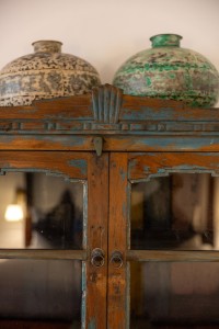 A suite interior and its furnishings: four-poster bed, carved cabinets and decorative pieces.