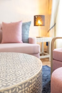 A suite interior and its furnishings: four-poster bed, carved cabinets and decorative pieces.