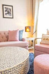 A suite interior and its furnishings: four-poster bed, carved cabinets and decorative pieces.