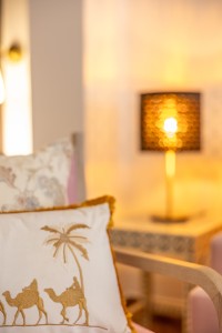 A suite interior and its furnishings: four-poster bed, carved cabinets and decorative pieces.