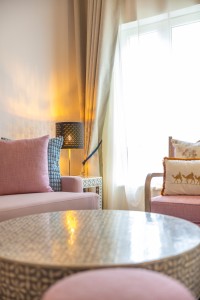 A suite interior and its furnishings: four-poster bed, carved cabinets and decorative pieces.