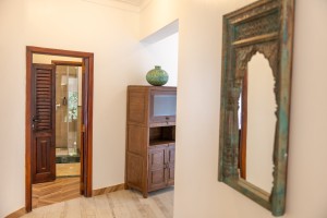 A suite interior and its furnishings: four-poster bed, carved cabinets and decorative pieces.