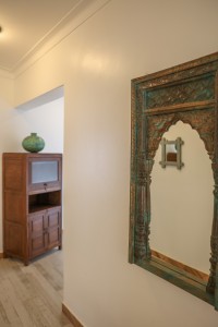 A suite interior and its furnishings: four-poster bed, carved cabinets and decorative pieces.
