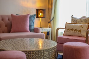 The separate lounge of a suite, with sofa, armchairs and a low round table.