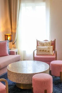 The separate lounge of a suite, with sofa, armchairs and a low round table.