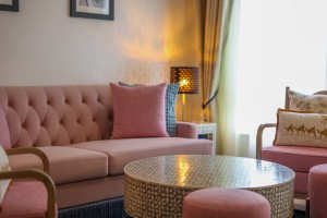 The separate lounge of a suite, with sofa, armchairs and a low round table.
