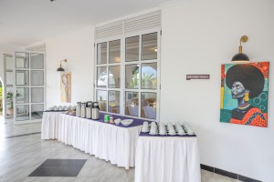 A dressed table of cups, saucers and vacuum flasks set for a conference tea break.