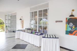 A dressed table of cups, saucers and vacuum flasks set for a conference tea break.
